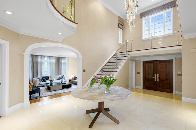 entryway with crown molding and light tile patterned floors