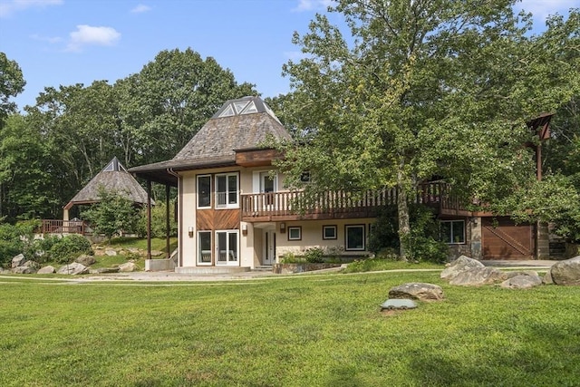 back of house featuring a wooden deck and a yard