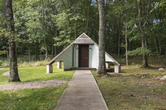 view of outbuilding featuring a yard