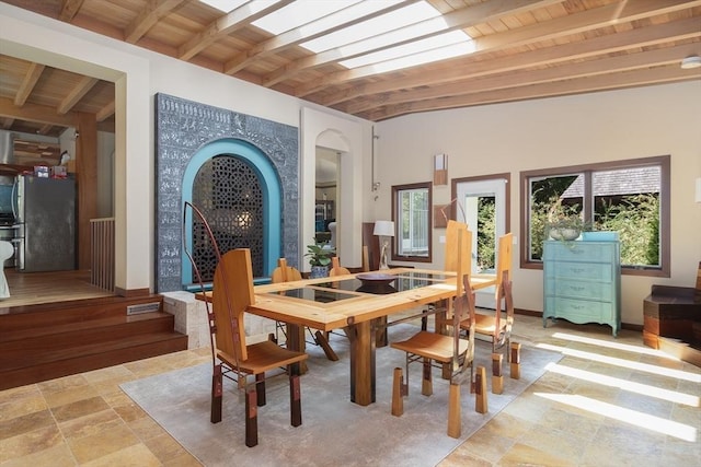 dining area featuring beam ceiling and wood ceiling