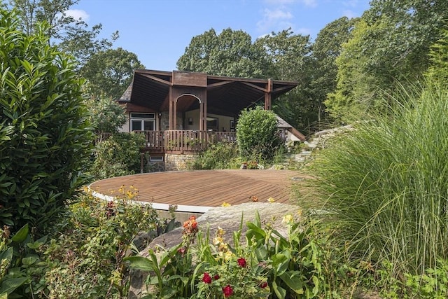 back of property featuring a wooden deck