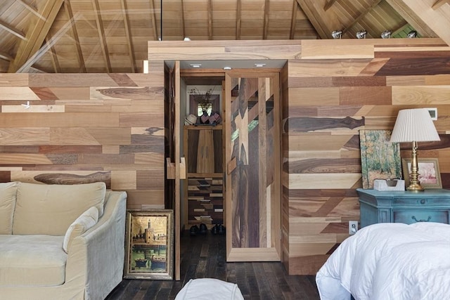 bedroom featuring wood walls and lofted ceiling