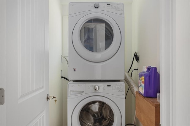 clothes washing area with stacked washer / drying machine