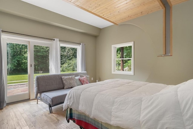 bedroom with wooden ceiling, multiple windows, light hardwood / wood-style flooring, and access to outside