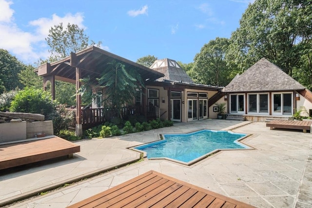 view of swimming pool featuring an outbuilding and a patio