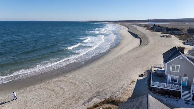 bird's eye view featuring a water view and a view of the beach