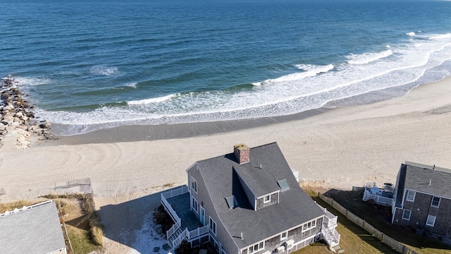 birds eye view of property with a water view and a view of the beach