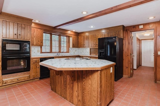 kitchen with light tile patterned flooring, sink, a kitchen island, beam ceiling, and black appliances