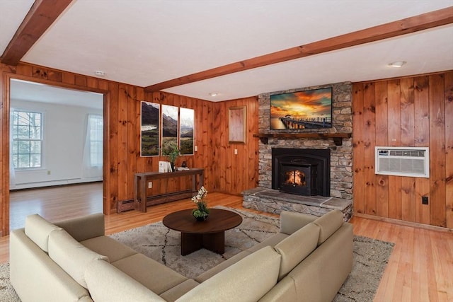 living room featuring a baseboard radiator, beam ceiling, a wall unit AC, and a fireplace