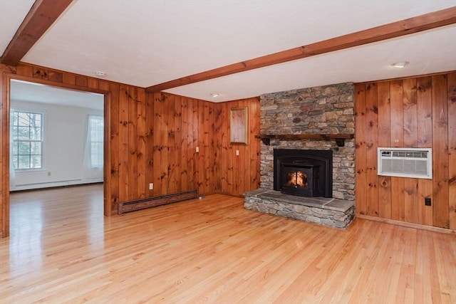 unfurnished living room featuring wooden walls, beam ceiling, and a baseboard heating unit