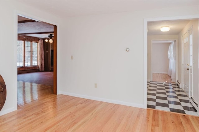 empty room with light hardwood / wood-style flooring and ceiling fan