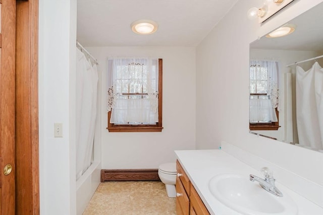 bathroom featuring vanity, a baseboard heating unit, and toilet