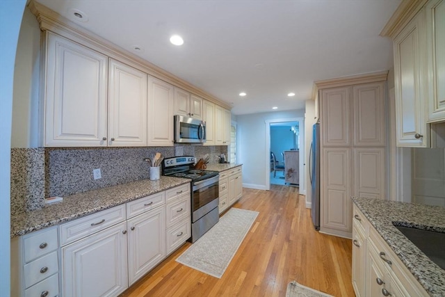642 Centre St, Newton, MA 02458 - kitchen featuring appliances with stainless steel finishes, tasteful backsplash, light wood-style flooring, baseboards, and recessed lighting
