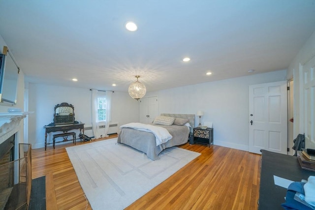 642 Centre St, Newton, MA 02458 - bedroom with radiator, recessed lighting, light wood-type flooring, a fireplace with flush hearth, and baseboards