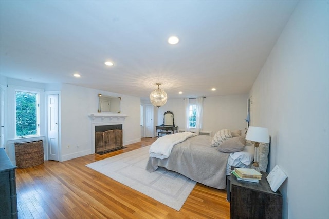 642 Centre St, Newton, MA 02458 - bedroom with a fireplace with flush hearth, light wood finished floors, recessed lighting, and baseboards