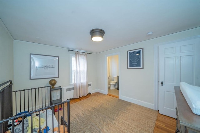 642 Centre St, Newton, MA 02458 - bedroom with wood finished floors, baseboards, and radiator heating unit