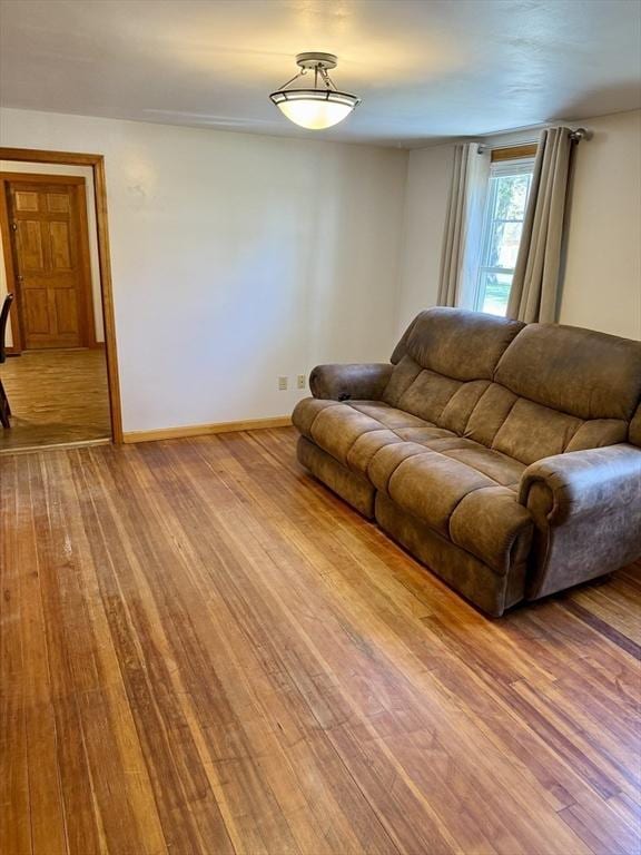 living room with baseboards and wood finished floors