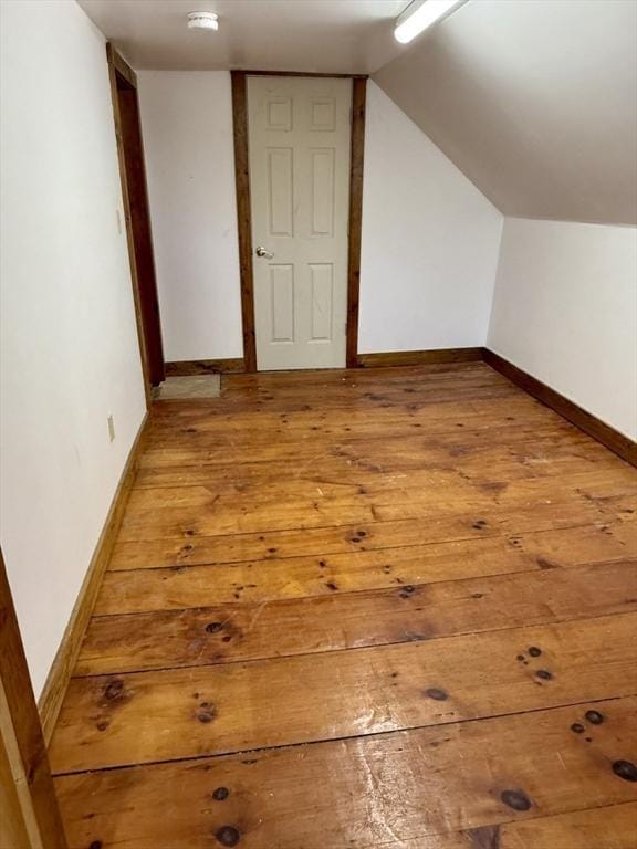 bonus room featuring baseboards and light wood-style flooring