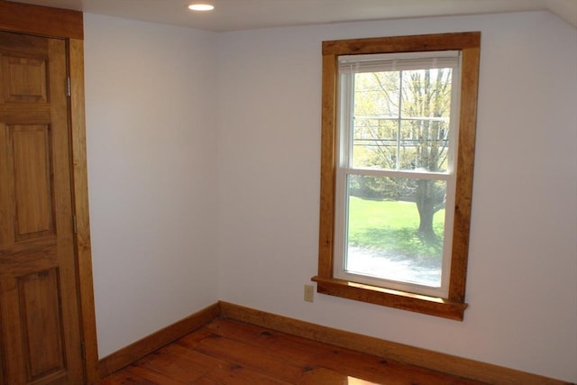 spare room featuring recessed lighting, baseboards, hardwood / wood-style flooring, and a wealth of natural light