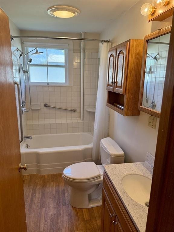 bathroom with vanity, shower / bath combo with shower curtain, toilet, and wood finished floors