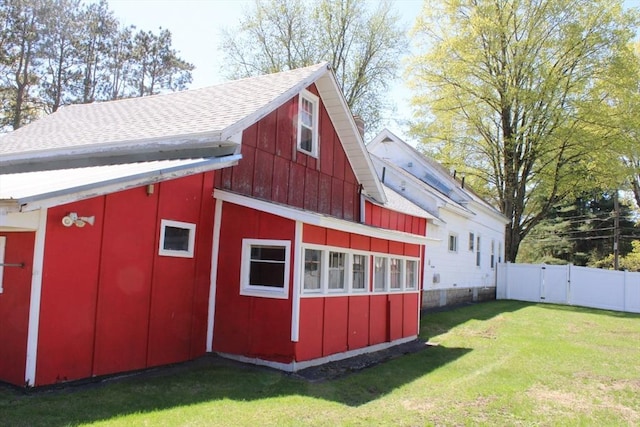 view of barn with a yard, fence, and a gate
