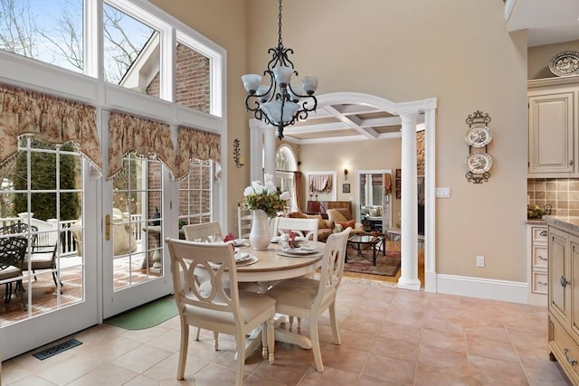 dining room with visible vents, coffered ceiling, decorative columns, and an inviting chandelier