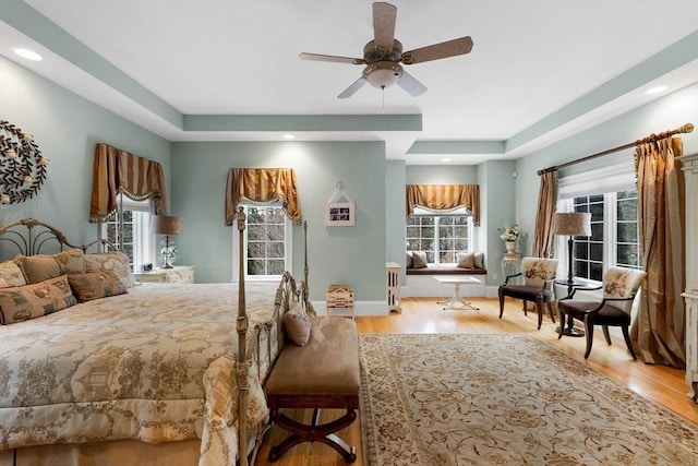 bedroom with recessed lighting, light wood-style flooring, and baseboards