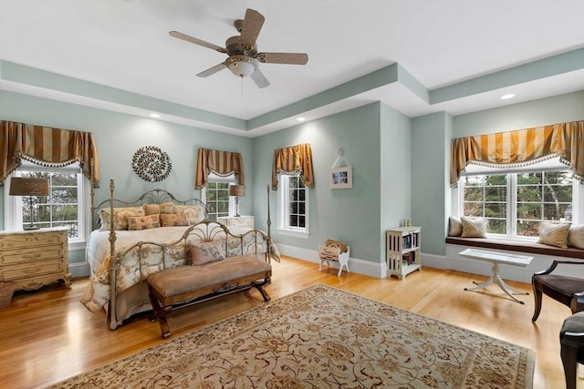 bedroom with baseboards, recessed lighting, a ceiling fan, and light wood-style floors