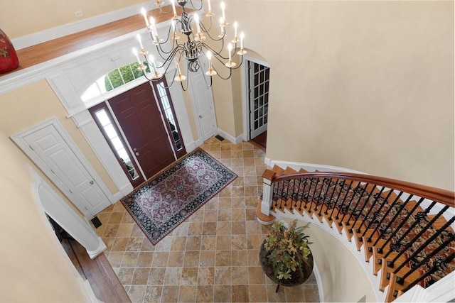 tiled entryway with stairway and baseboards