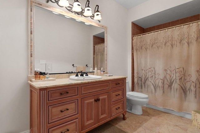 bathroom featuring toilet, a notable chandelier, and vanity