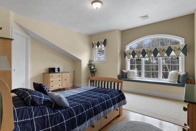 bedroom featuring baseboards and wood finished floors