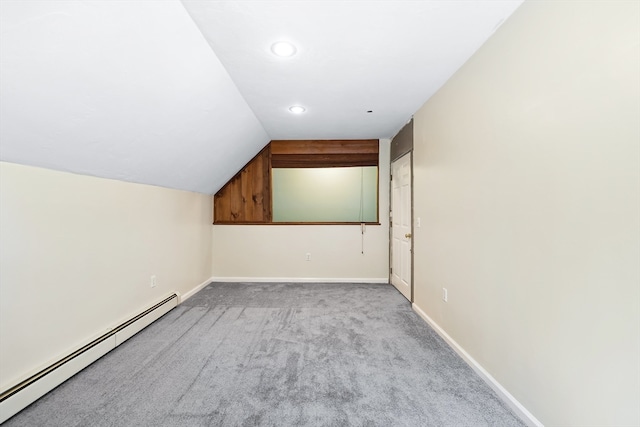 bonus room with a baseboard heating unit, light colored carpet, and lofted ceiling