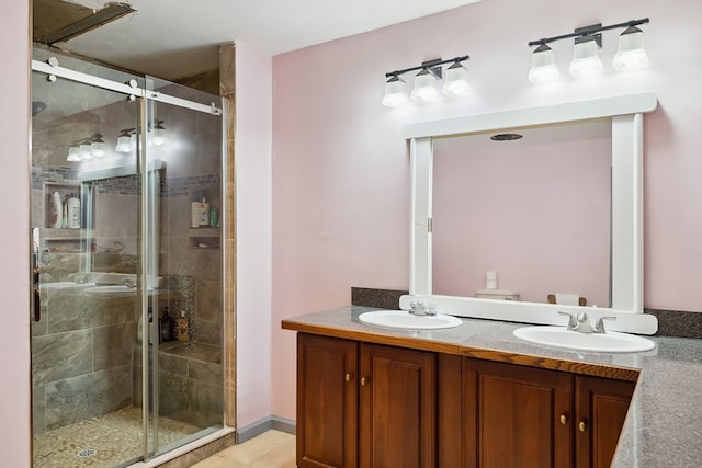 bathroom featuring vanity and a shower with shower door