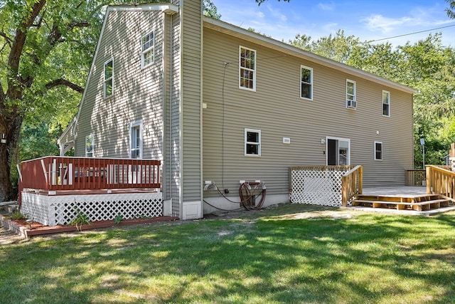 rear view of property featuring a yard and a wooden deck