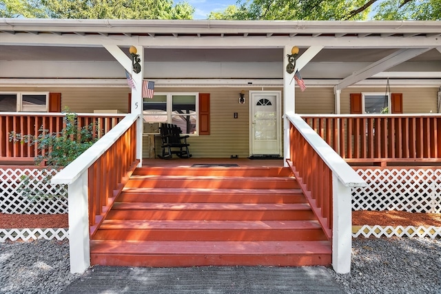 doorway to property featuring covered porch