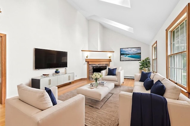 3 Plymouth Heights Rd, Bourne, MA 02562 - living area featuring a skylight, light wood-style floors, baseboard heating, a fireplace, and high vaulted ceiling