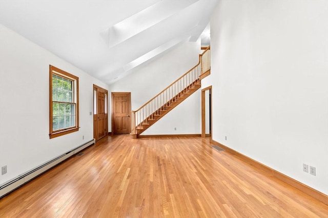 3 Plymouth Heights Rd, Bourne, MA 02562 - unfurnished living room featuring a baseboard radiator, light wood-style floors, a skylight, stairs, and baseboards