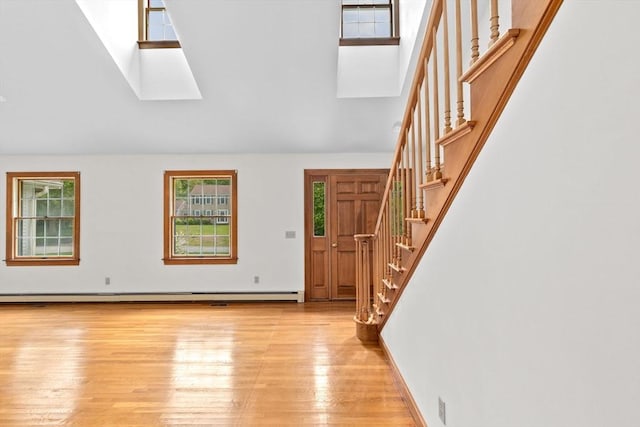 3 Plymouth Heights Rd, Bourne, MA 02562 - entrance foyer featuring a skylight, light wood-style floors, healthy amount of natural light, stairs, and a towering ceiling