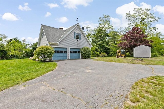 3 Plymouth Heights Rd, Bourne, MA 02562 - view of side of home with asphalt driveway, an attached garage, a lawn, a chimney, and a shingled roof