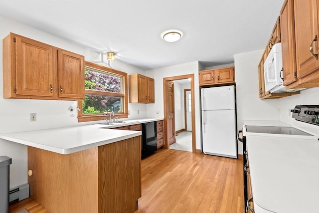 3 Plymouth Heights Rd, Bourne, MA 02562 - kitchen featuring white appliances, baseboard heating, a peninsula, light wood-style floors, and light countertops