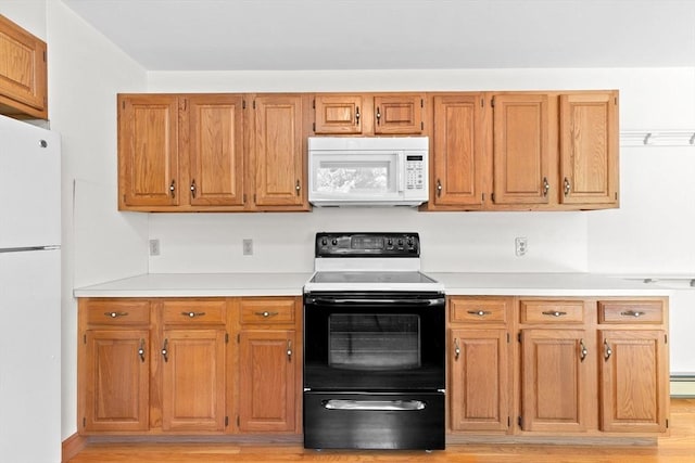 3 Plymouth Heights Rd, Bourne, MA 02562 - kitchen with white appliances, light countertops, light wood finished floors, and brown cabinetry