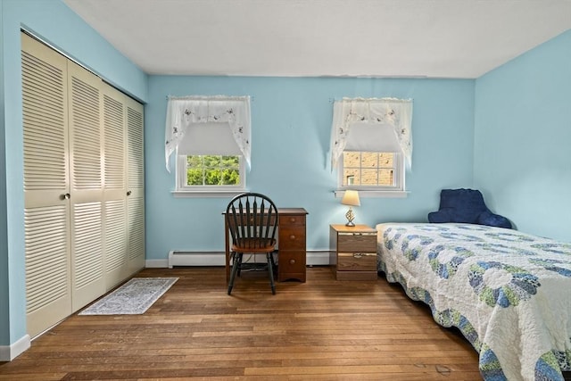 253 Rock St Unit 253, Norwood, MA 02062 - bedroom with hardwood / wood-style floors, a closet, baseboard heating, and a baseboard radiator