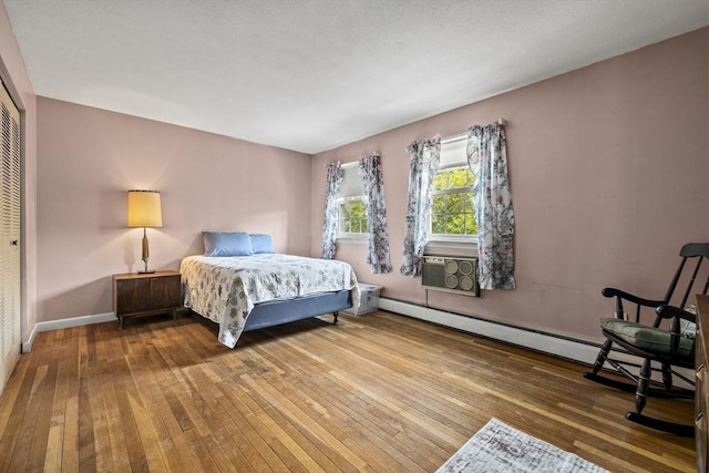 253 Rock St Unit 253, Norwood, MA 02062 - bedroom featuring hardwood / wood-style flooring, a closet, cooling unit, and a baseboard heating unit