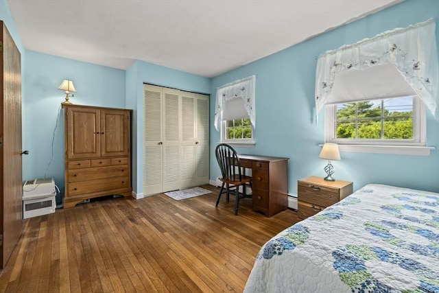 253 Rock St Unit 253, Norwood, MA 02062 - bedroom featuring multiple windows, hardwood / wood-style flooring, a closet, and a baseboard radiator