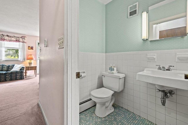 253 Rock St Unit 253, Norwood, MA 02062 - ensuite bathroom with a baseboard radiator, wainscoting, tile patterned flooring, and tile walls