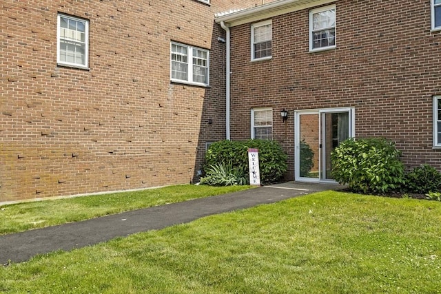 253 Rock St Unit 253, Norwood, MA 02062 - back of property with a lawn and brick siding