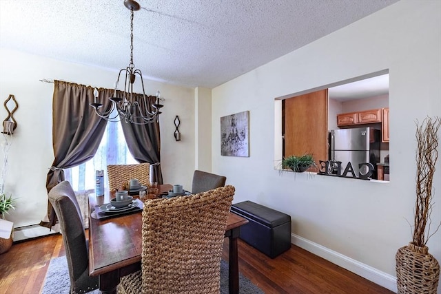 dining area with a notable chandelier, dark hardwood / wood-style floors, a textured ceiling, and baseboard heating