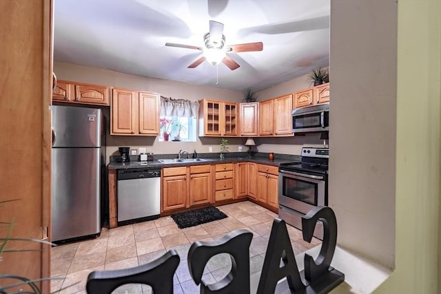 kitchen featuring sink, light tile patterned floors, ceiling fan, appliances with stainless steel finishes, and light brown cabinetry