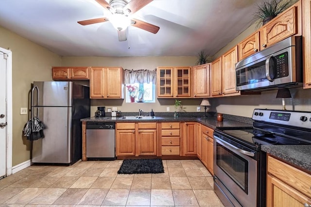 kitchen with sink, light tile patterned floors, stainless steel appliances, and ceiling fan