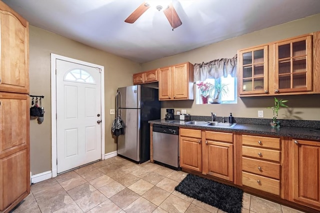 kitchen featuring ceiling fan, stainless steel appliances, and sink